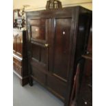 Antique oak side cabinet with a single panelled door flanked by a single panel with a panel below