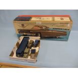 Five various die-cast metal model vehicles together with a later boxed tin plate model Cadillac car