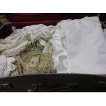 Grey suitcase containing a quantity of various linen and lace together with another grey suitcase