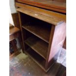 20th Century oak open bookcase having three deep shelves raised on a plinth base (a/f)