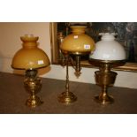 Three brass oil lamps adapted for use with electricity