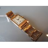 9ct Yellow gold cased gentleman's wristwatch with rectangular silvered dial having Arabic numerals