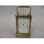 Early 20th Century brass cased carriage clock, the enamel dial with Arabic and Roman numerals,