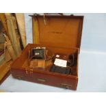 Two leather cased folding cameras, small leather suitcase (a/f),