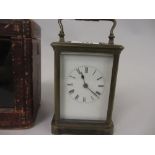 Early 20th Century brass cased carriage clock, the enamel dial with Roman numerals,