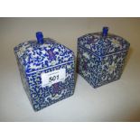 Pair of 20th Century Chinese square shaped canisters with covers decorated with floral designs on a