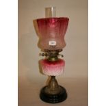 Victorian brass and opaque glass oil lamp with cranberry glass shade
