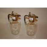 Pair of silver plated lidded claret jugs with clear glass dimple bodies together with a plated