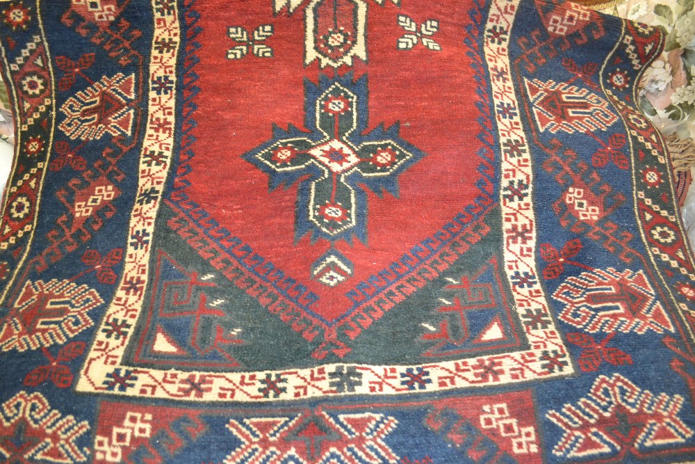 Turkish rug with triple medallion on a wine ground,