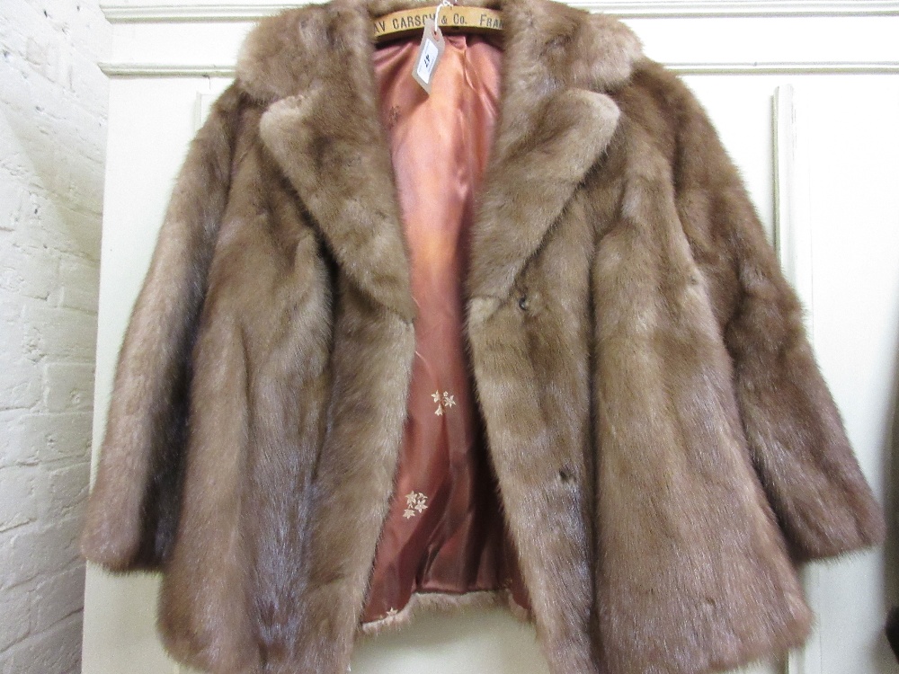 Ladies short light coloured fur jacket