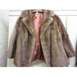 Ladies short light coloured fur jacket