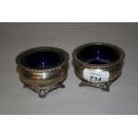 Pair of Birmingham silver circular salts with blue glass liners