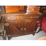 Victorian Gothic revival oak side cabinet with a single frieze drawer above two panelled doors with