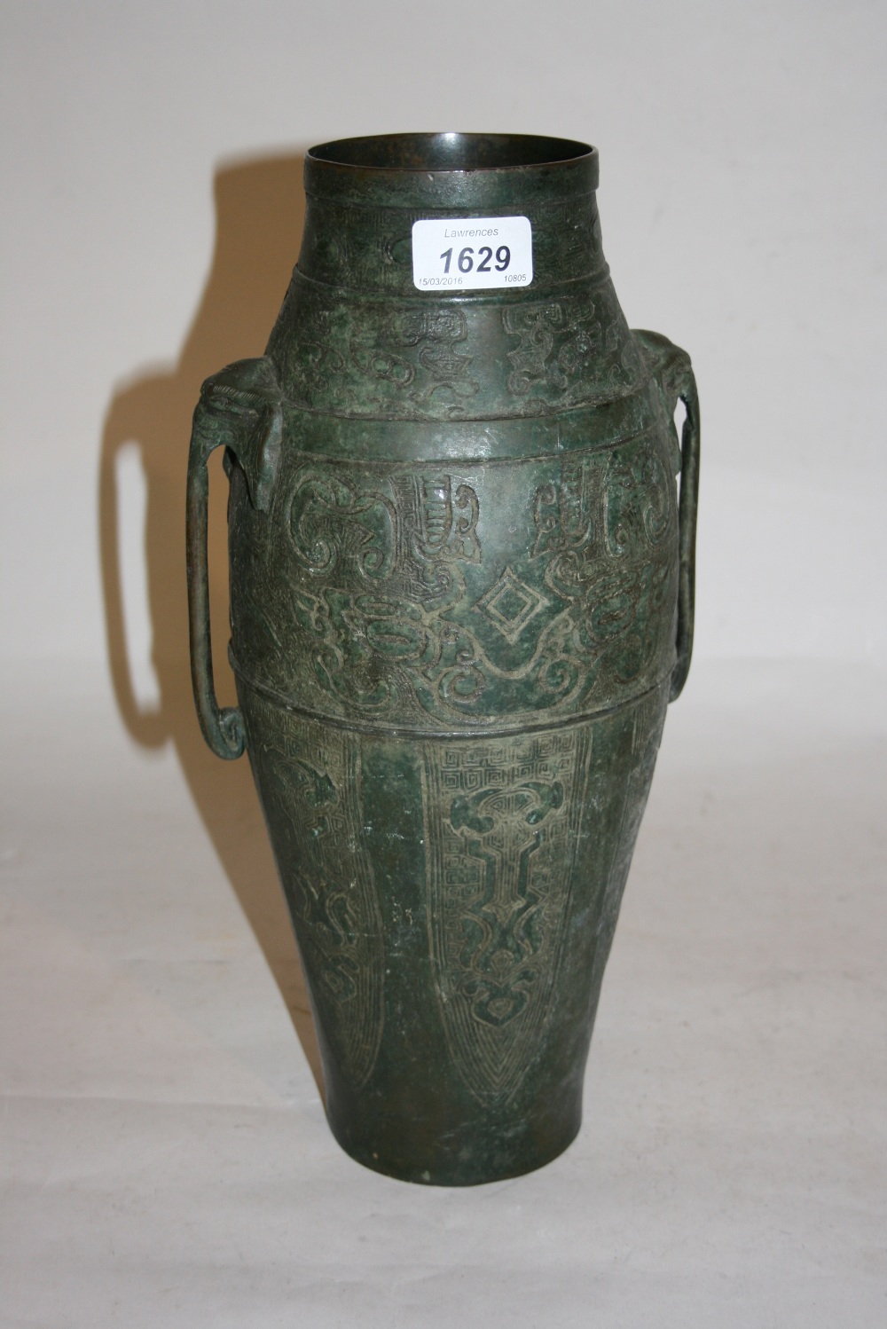 Chinese patinated bronze two handled vase with relief decoration,