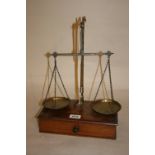 Pair of 19th Century brass balance scales on a single drawer box base together with a small set of