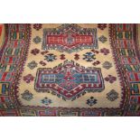 Mid 20th Century Turkish rug with four hooked medallions on a beige ground with borders,