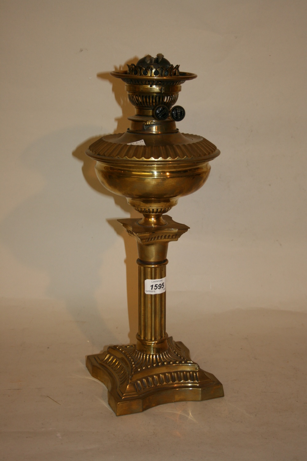 Late 19th or early 20th Century brass oil lamp and well with clear glass shade and chimney