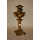 Late 19th or early 20th Century brass oil lamp and well with clear glass shade and chimney