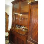 Large 19th Century bookcase having moulded cornice above two glazed panelled doors with shelved