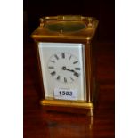 Early 20th Century brass cased carriage clock, the enamel dial with Roman numerals,
