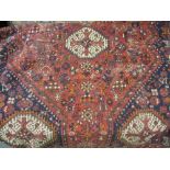 Shiraz rug having all-over multiple medallion and floral design with multiple borders on a red