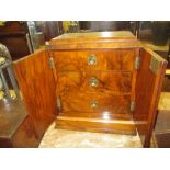Victorian walnut table cabinet with two doors enclosing three drawers