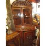 Pair of Victorian carved oak standing corner cabinets,