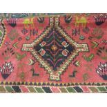 20th Century rug with medallion design on a pink ground with borders together with another 20th