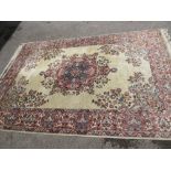 Indian rug with medallion and floral design on a beige ground with borders