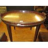 George III oval mahogany brass banded two handled tray on a later stand