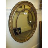 Reproduction oval gilt framed segmented wall mirror,