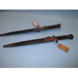 Two World War II bayonets with scabbards