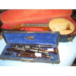 Dulcetta banjo ukelele in a fitted case (a/f) together with two woodwind instruments and a metal