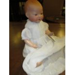 Armand Marseille bisque headed baby doll dressed in a Christening gown