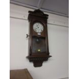 Walnut cased Seth Thomas Vienna style wall clock having carved decoration and a circular dial with
