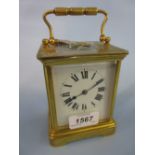 French gilt brass carriage clock with enamel dial and Roman numerals and a two train striking
