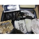 Large suitcase containing a quantity of various mid 20th Century ladies evening bags and leather