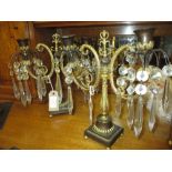 Pair of Regency gilded and brown patinated bronze two branch candelabra with glass drops