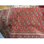 Red ground Bokhara style carpet, 2.3m x 1.