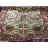 Small woollen Persian pattern rug with floral design on a beige ground