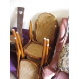 Set of four modern bentwood dining chairs with cane backs and seats
