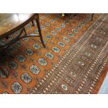 Pakistan Bokhara pattern carpet on a rust ground,