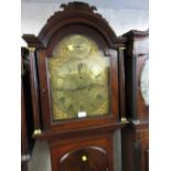 George III mahogany longcase clock with an arched hood above arched panel door and a plinth base,