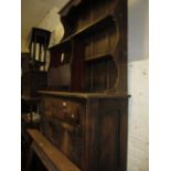 Small early 20th Century oak dresser with boarded shelf back above a drawer and cupboard doors