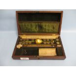 Mahogany cased brass hydrometer with weights, ivory backed thermometer and two ivory sliding rules,