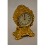 Small 19th Century gilt brass clock, the silvered dial with Roman numerals,