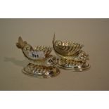 Pair of silver plated shell and dolphin form table salts