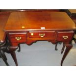 Mahogany lowboy in 18th Century style, the moulded top with pinched corners above three drawers,