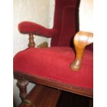 Red Arts and Crafts walnut and red upholstered open arm library chair on turned tapering front