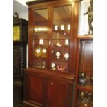 19th Century mahogany bookcase with a moulded cornice above two glazed doors with two panelled